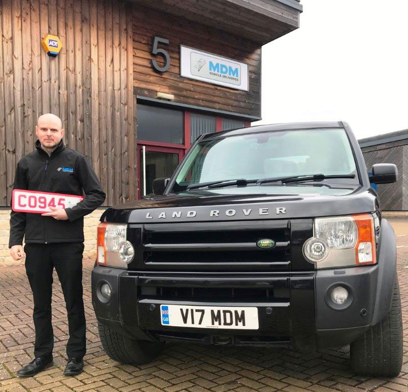Driver holding number plates